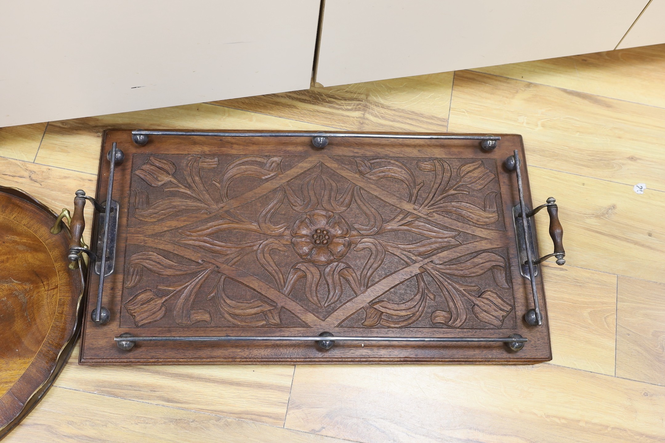 An oval, shell inlaid, pie crust tray and a carved oak rectangular tray, with chrome gallery and handles, oak tray 67 cms wide.